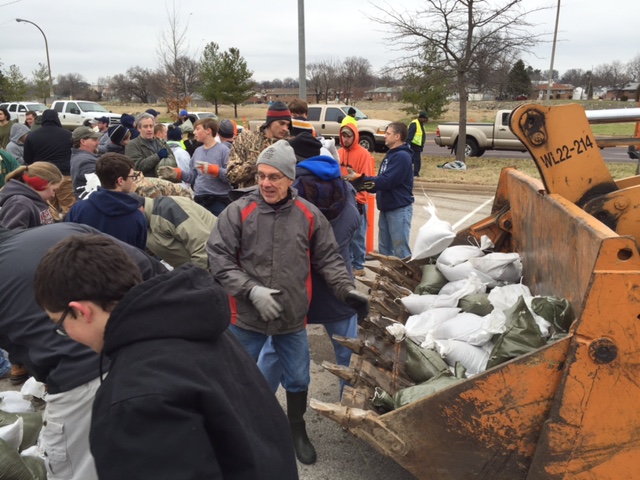 Volunteers load sand bags for the River Des Peres Levee